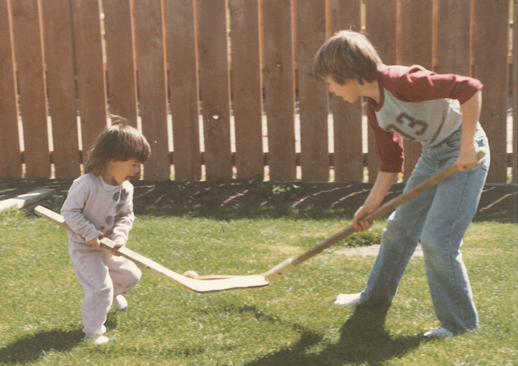 Paul playing hockey with his little sister.