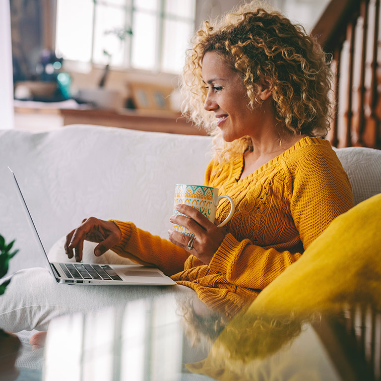 bcss british columbia schizophrenia society person using laptop while holding mug